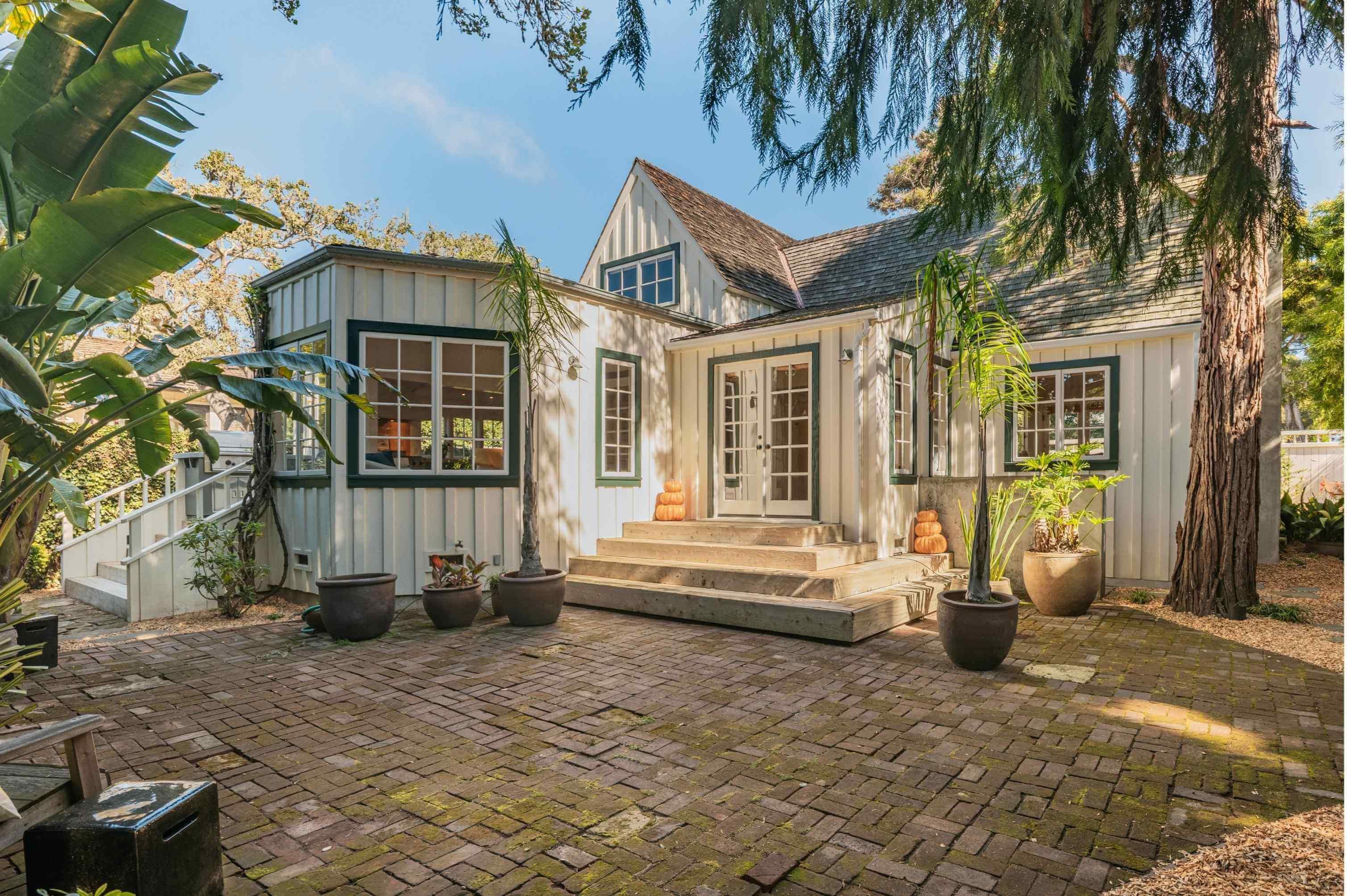 For sale sign in front of a Carmel home with ocean views on the Monterey Peninsula