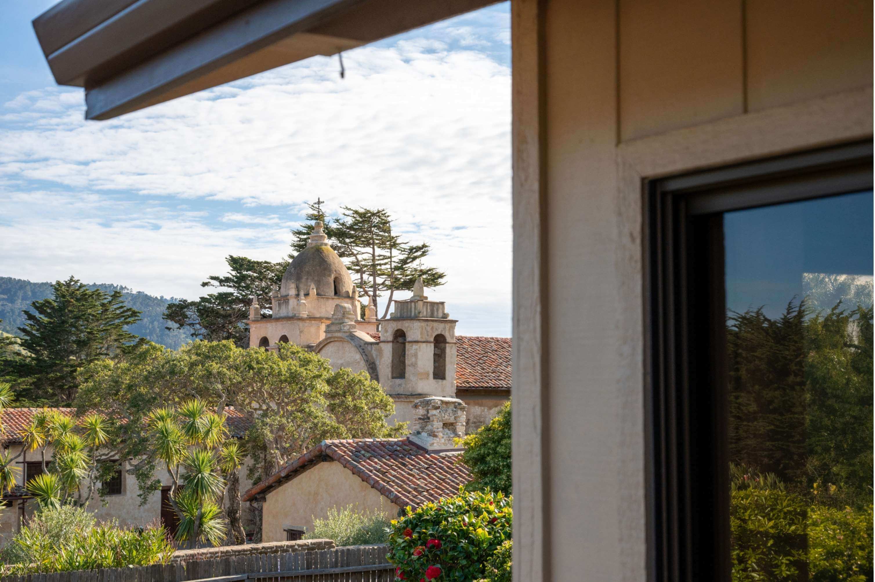 Exterior view of a luxury craftsman-style home in Carmel, featuring stone pathways, lush landscaping, and classic Monterey Peninsula architecture.