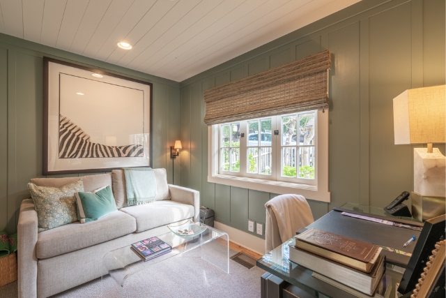Versatile home office and den space with custom green paneling in Carmel luxury real estate.