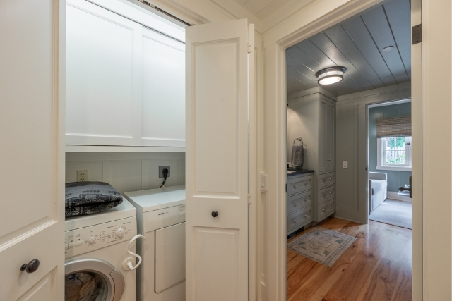 Convenient laundry area and built-in storage hallway in Carmel-by-the-Sea home.