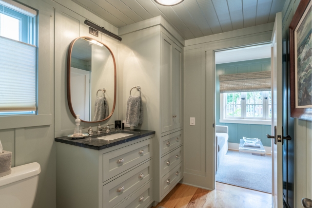 Elegant luxury bathroom vanity with a custom mirror and cabinetry in Golden Rectangle cottage.
