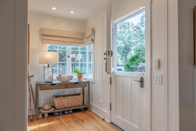 Bright entryway featuring a classic Dutch door and hardwood floors in Golden Rectangle real estate.