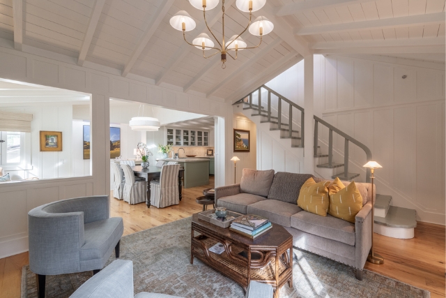 Open living space showing the staircase and seamless flow into the dining area and kitchen.