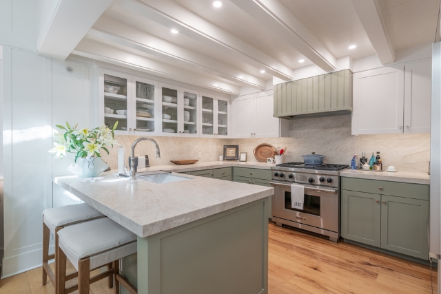 Stunning open concept kitchen with high-end stainless steel appliances and custom stone countertops in Carmel.