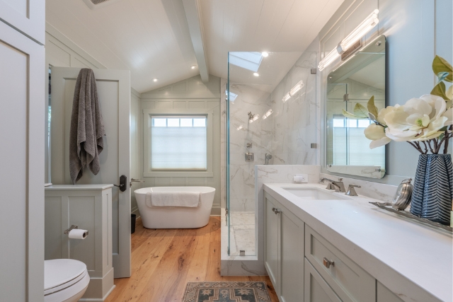 Luxury en-suite bathroom featuring a glass walk-in shower and custom cabinetry in Carmel-by-the-Sea home.
