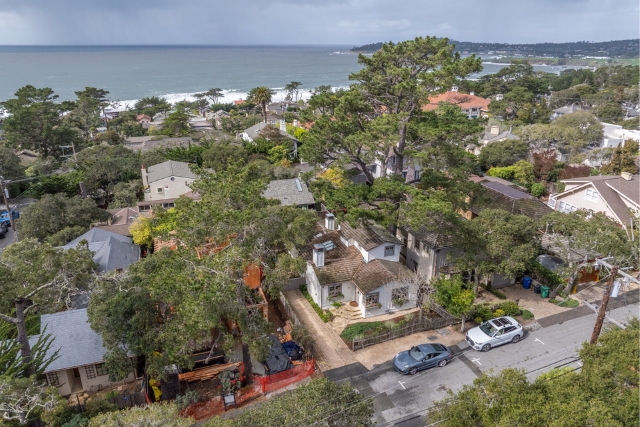 Wide drone shot highlighting the Monterey Peninsula coastline and Carmel Beach neighborhood.
