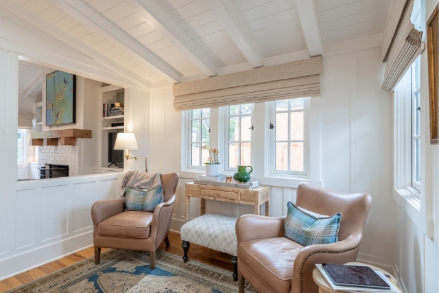Cozy living area with a fireplace and vaulted beamed ceilings in Carmel luxury home.