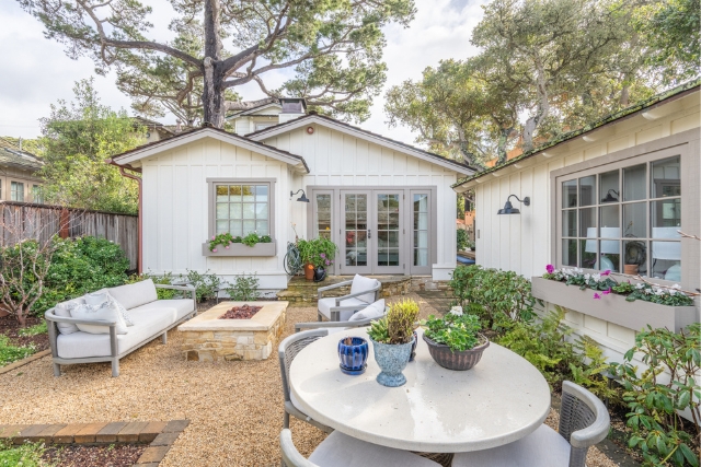Beautiful outdoor entertaining space with a custom stone fire pit at Golden Rectangle property.